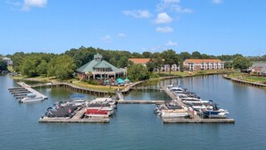 A marina with docked boats, a covered pavilion, and residential buildings in the background. - Lake Norman Dream Condo! 1st Floor, Lake View Lake Norman Vacation Rental (Cornelius)