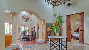 A spacious room with a patterned floor, a round table, and a large plant. - Casa Sur, Hacienda Living in Merida Centro (Mérida)
