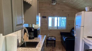 A compact kitchen with granite countertops, a built-in stove, and a refrigerator. - TWO Waterfront Camps on Sebago Lake (Standish)