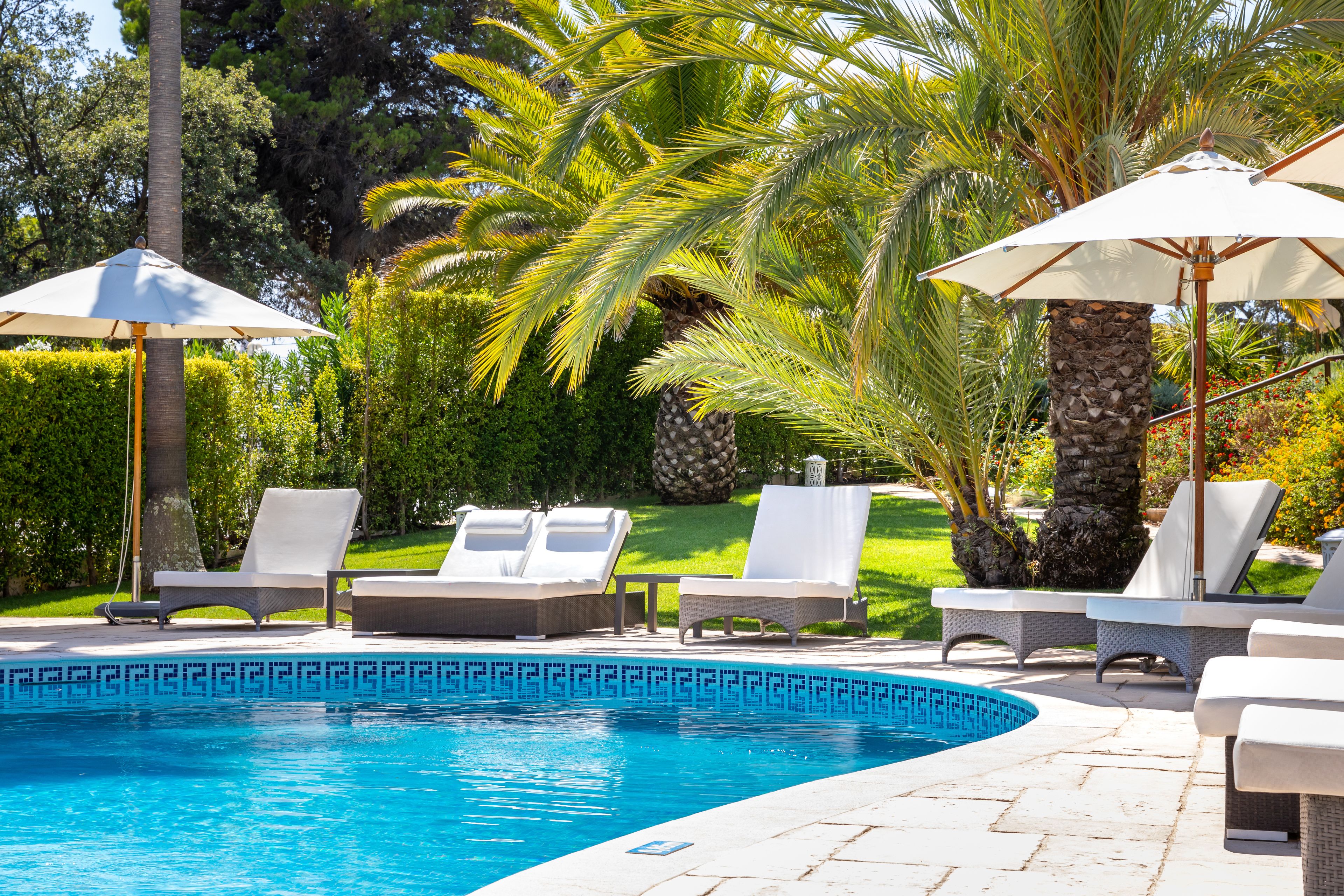 Outdoor pool, a heated pool, open 8:30 AM to 8:30 PM, pool umbrellas