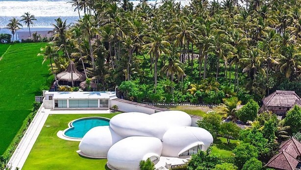 A resort with a pool, white dome-shaped structures, and a view of the ocean. - The Cloud Unique Beachfront Villa (Tabanan)