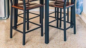 A dining area with a wooden table and four chairs, a vase with flowers, and a bottle on the table. - #4 ❤️ Sunny, Newly Furnished 1BR apt (Fort Lauderdale)
