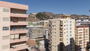 A multi-story residential building with balconies, a clear sky, and a hilly landscape in the background. - LIDER, 10-B (Cullera)