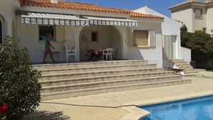 A two-story house with a swimming pool, outdoor seating, and a staircase leading to the patio. - Villa Los Balconess,<br>Is available from  6 nights (Torrevieja)