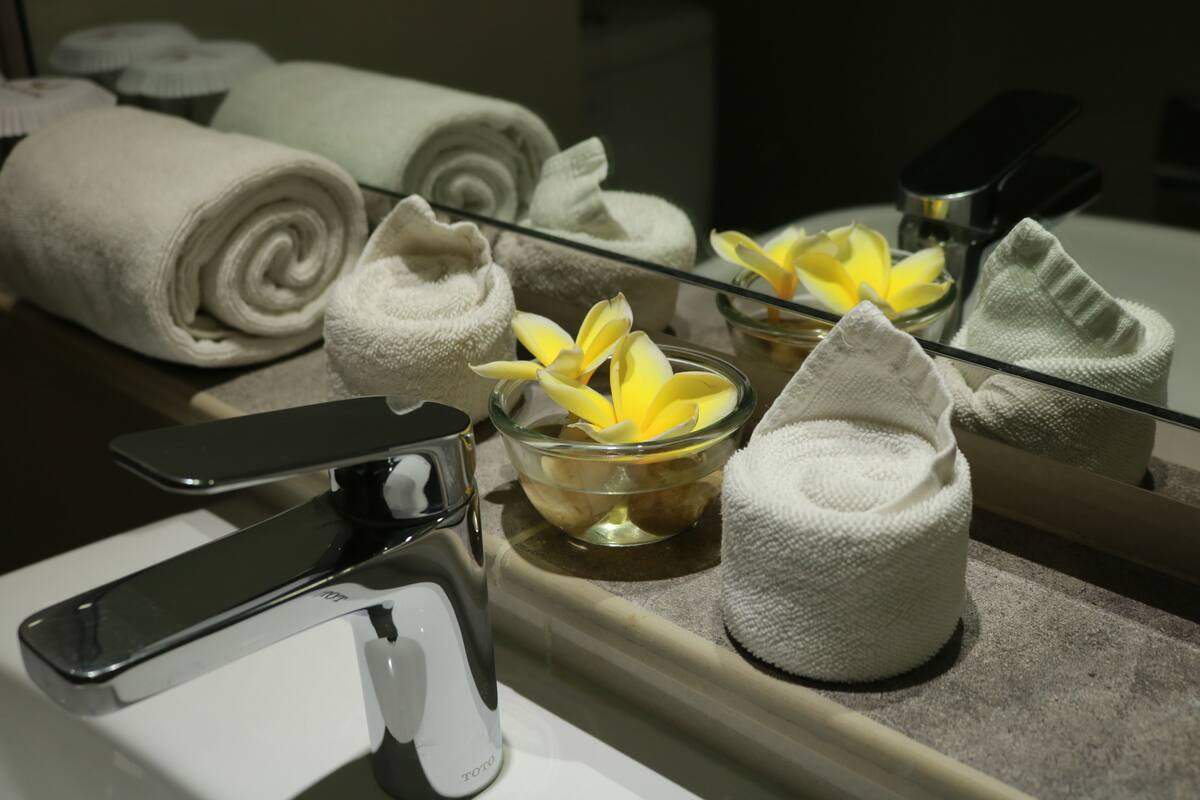 shower, hair dryer, slippers, towels