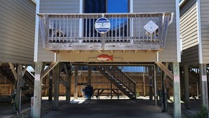 A two-story building with a balcony, a fire lane sign, and a Dolphin Realty sign. - Put your Anchor down with Nautical Nine! Beachfront, Pet Friendly Cabana! (HATTERAS)