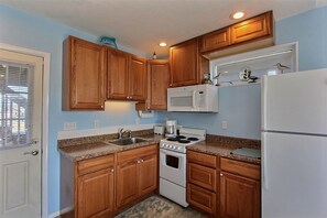 Fridge, microwave, stovetop, cookware/dishes/utensils