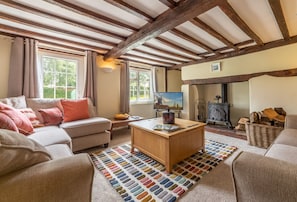 Ground floor: Sitting room with wood burning stove and original beams