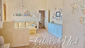 A cozy living room with a checkered sofa, a chandelier, and a blue cabinet. - Beautiful View in a Shabby Chic Atmosphere (Padenghe Sul Garda)