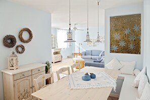 A cozy dining area with a wooden table, chairs, and a decorative centerpiece.