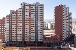 A high-rise residential building with multiple balconies and a central courtyard. - MONTEMAR, C-12º-33 (Cullera)