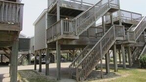 A multi-level wooden structure with external staircases, likely a deck or observation platform. - A Dune Away is the place to stay! (HATTERAS)