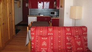 A compact kitchen with a microwave, sink, and red cabinets. - Cozy Duplex for 5, Close to Ski Lifts & Shops, South-Facing Balcony – Alpe d'Huez (Huez)