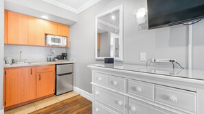 Enjoy cooking in this well-equipped kitchen with a refrigerator, microwave, and flat-screen TV.