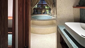 A bathroom with a large bathtub, a sink, and a view of a pool through a window. - The Memory Danang Boutique (Da Nang)