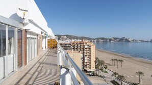 A balcony with a view of a beach and a hotel building. - LIDER, 12-A (Cullera)