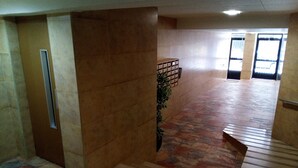 A hallway with a tiled floor, a potted plant, and a storage unit. - PROVENCE, 5º-18 (Cullera)
