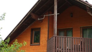 A wooden cabin with a balcony, a window, and a visible chimney. - Apartment Jan, Pakaljski odvojak 4, 53220 Otočac, Licko-Senjska county, Croatia (Otočac)