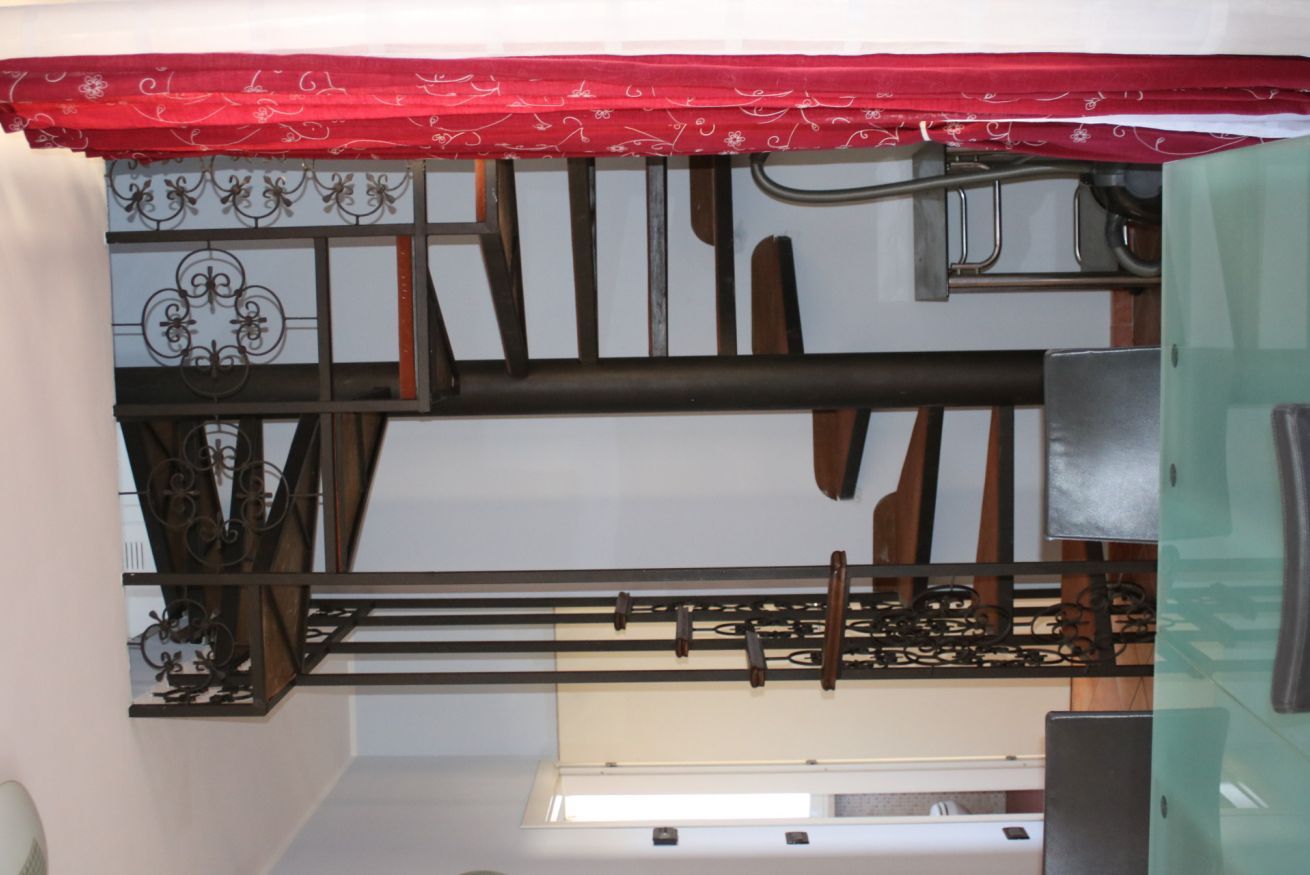 A kitchen with a gas stove, a sink, and a window above the counter.