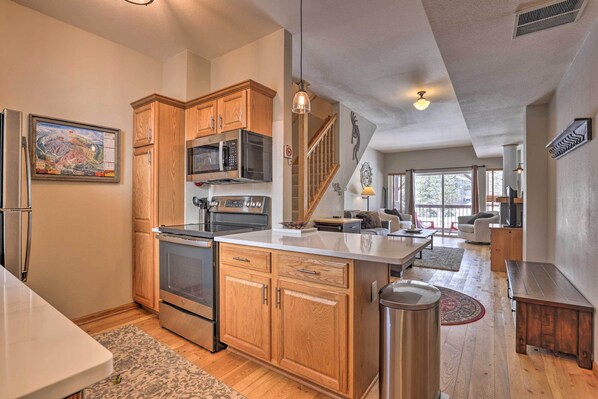 Enjoy cooking in this well-equipped kitchen with a central island, oven, and microwave.