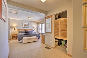 Relax in this serene bedroom with a large bed, bedside table, and wooden wardrobe.