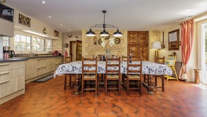 A dining area with a table set for six, surrounded by wooden chairs. - La Tronquiere (Lacropte)