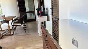 Una cocina con encimera de madera, un fregadero y una ventana con persianas.