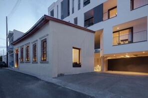 A modern building with a flat roof, large windows, and a garage entrance. - Alinea Suites Limassol Center (Limassol)