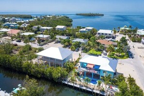 A coastal residential area with houses, a dock, and a beach.