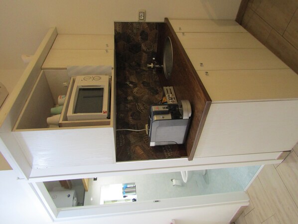 A compact, two-story apartment with a kitchenette on the upper floor, a visible bathroom, and a small window. - Civico 24 one-room apartment Monte Rosa (Scicli)