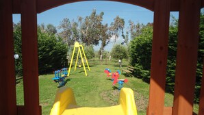 A playground with a yellow slide and various play equipment. - LE PESCINE - Lecci [SG] (Vada)