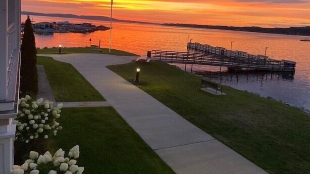 A waterfront property with a dock, a walking path, and a flagpole. - Boyne Mountain, Base of Mtn, Sleeps 13 (Boyne Falls)