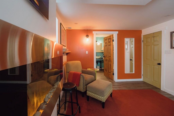 Inviting living space with warm orange accents and comfortable seating