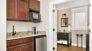 A kitchen with wooden cabinets, a microwave, a coffee maker, and a dishwasher.