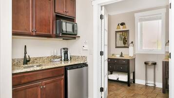 A kitchen with wooden cabinets, a microwave, a coffee maker, and a dishwasher.