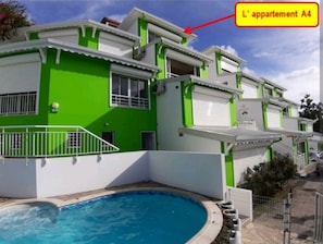 Un edificio residencial de varios pisos con piscina.