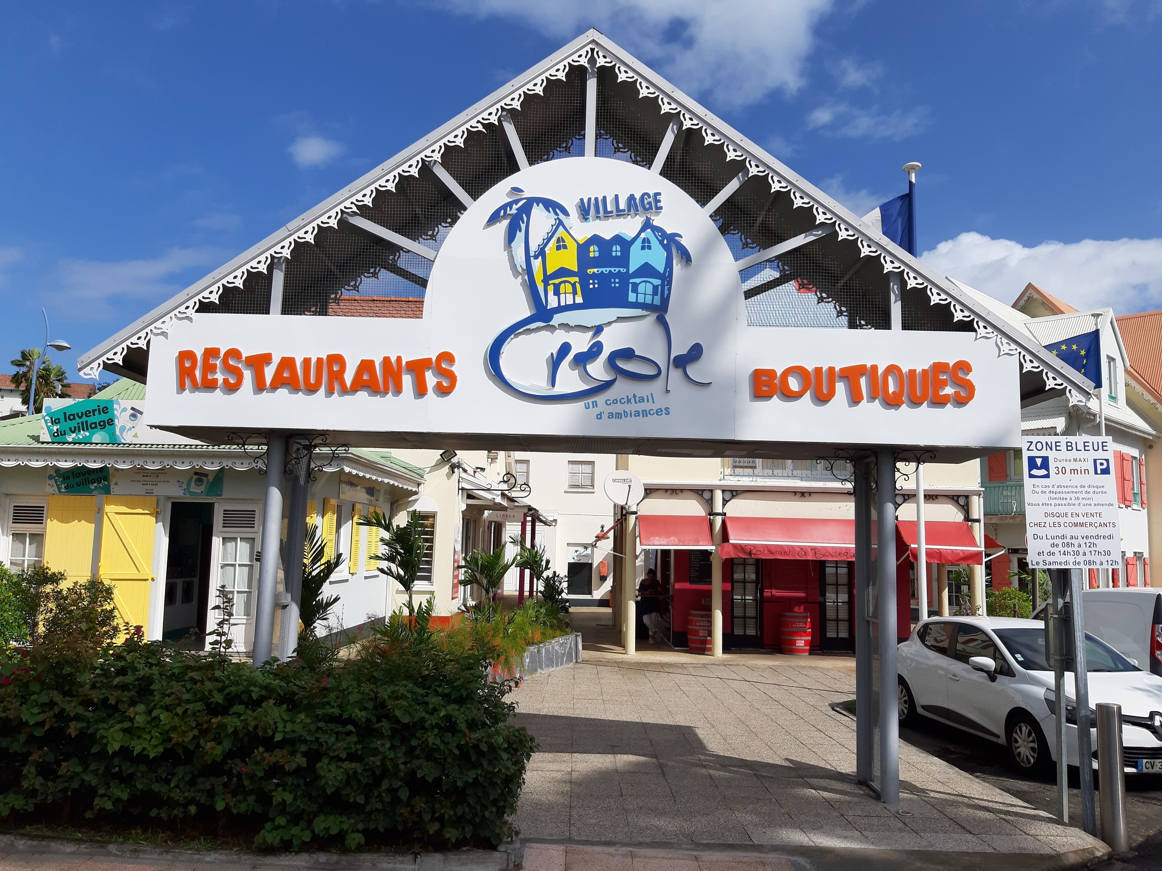 A building with a sign indicating it houses restaurants and boutiques.