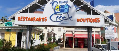 A building with a sign indicating it houses restaurants and boutiques.