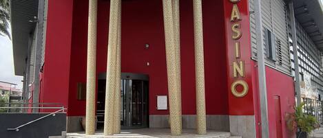 A building with a red facade and the word "CASINO" on the side.