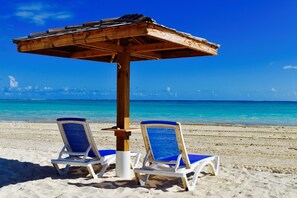 On the beach, sun loungers, beach towels