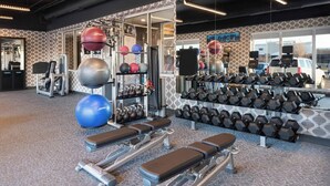 A gym with treadmills, weight benches, and various exercise equipment. - Aloft by Marriott Cincinnati West Chester (West Chester)