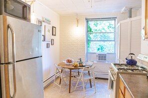 Enjoy cooking in this kitchen with a gas stove, refrigerator, and dining area.