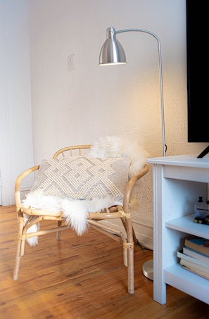 Relax in a peaceful space with a wicker chair, bookshelf, and reading nook.