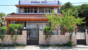 A two-story building with a sign reading "KUMSAL SUIT". - Kumsal Suit (Marmara)