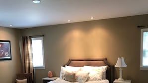 A bedroom with a bed, a nightstand, a lamp, and a window with curtains. - Walk to Carrollton Square!  Entire Home Upstairs For Rent.  (Carrollton)
