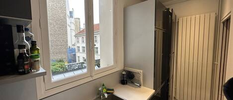 A modern kitchen with a window, a sink, and a radiator.