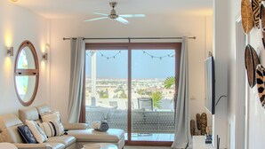 Ein modernes Wohnzimmer mit einer Couch, einem Couchtisch und einem Fernseher.