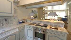 A kitchen with white cabinetry, a built-in oven, and a stove. - Welcome to Haus Ruusenhoog, the versatile vacation home located in picturesque Braderup (Braderup)