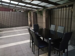 Relax in this serene patio area with a glass-top table and four comfortable chairs.