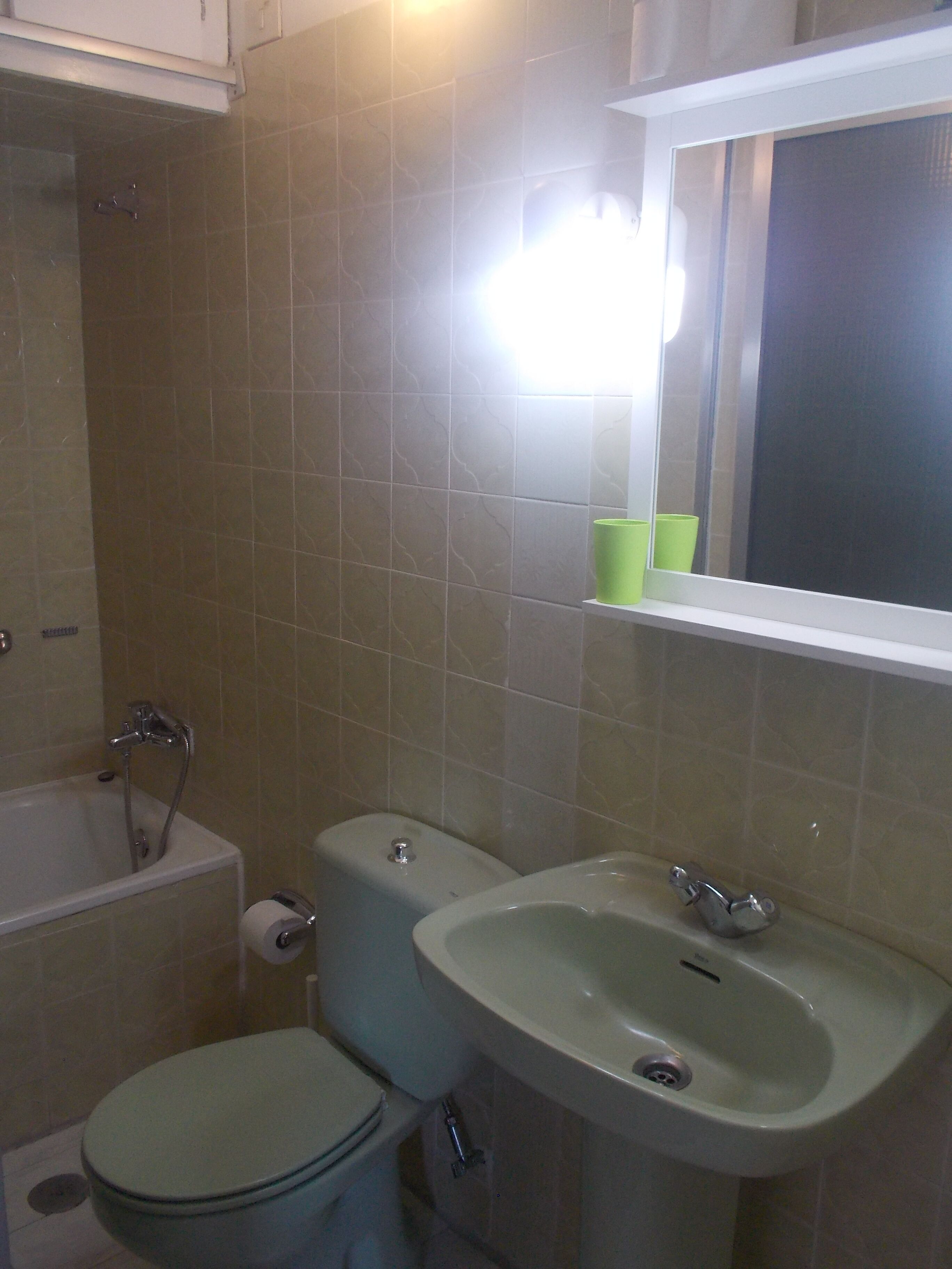 A bathroom with a toilet, sink, and bathtub.